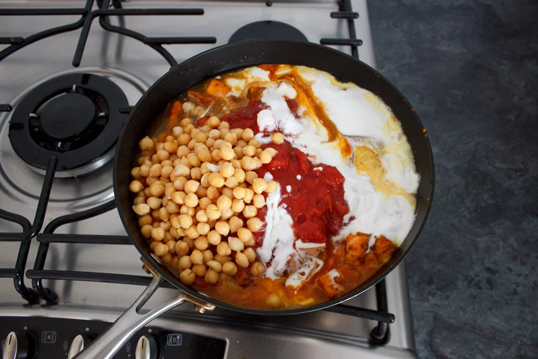 sweet potato chickpea curry ingredients all in a frying pan