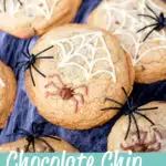 chocolate chip halloween spider cookies on a spider web with black plastic spiders. A text overlay says "chocolate chip spider cookies".