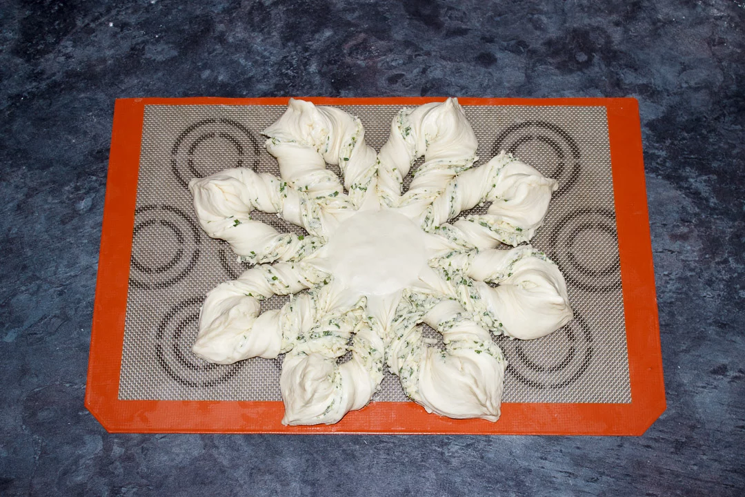Festive star pull apart pizza dough on a silicone mat