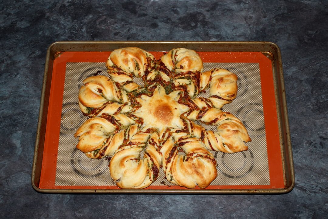 Baked festive star pull apart bread on a large lined baking tray