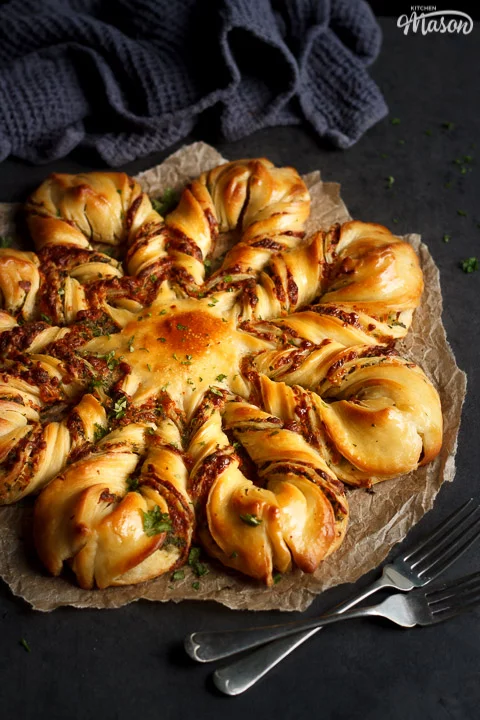 Festive Star Pull Apart Bread on a sheet of torn baking paper