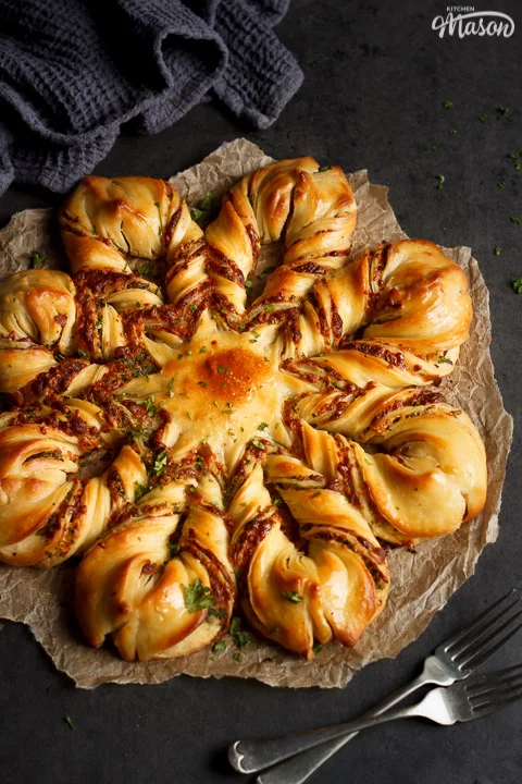 Festive Star Pull Apart Bread on a sheet of torn baking paper