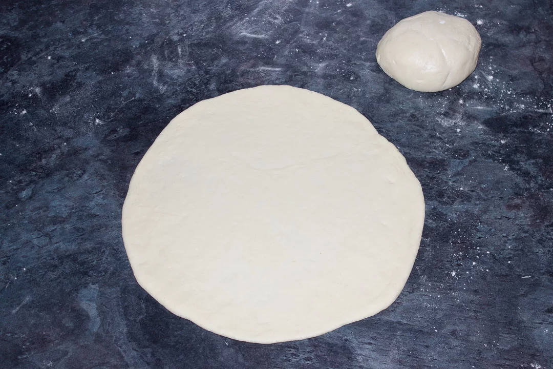 Pizza rdough rolled out into an 11" circle