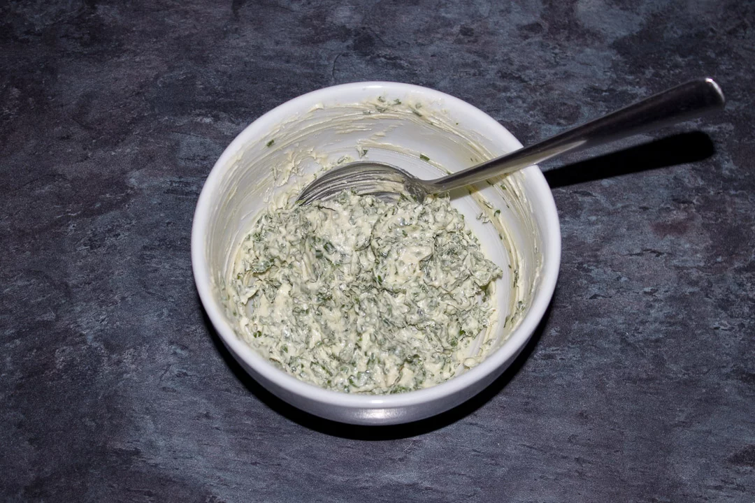Herby butter in a bowl with a spoon