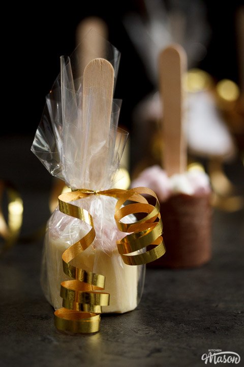 Hot chocolate stick wrapped in cellophane and tied with gold curling ribbon