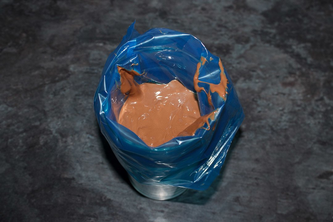 Melted milk chocolate in a disposable piping bag