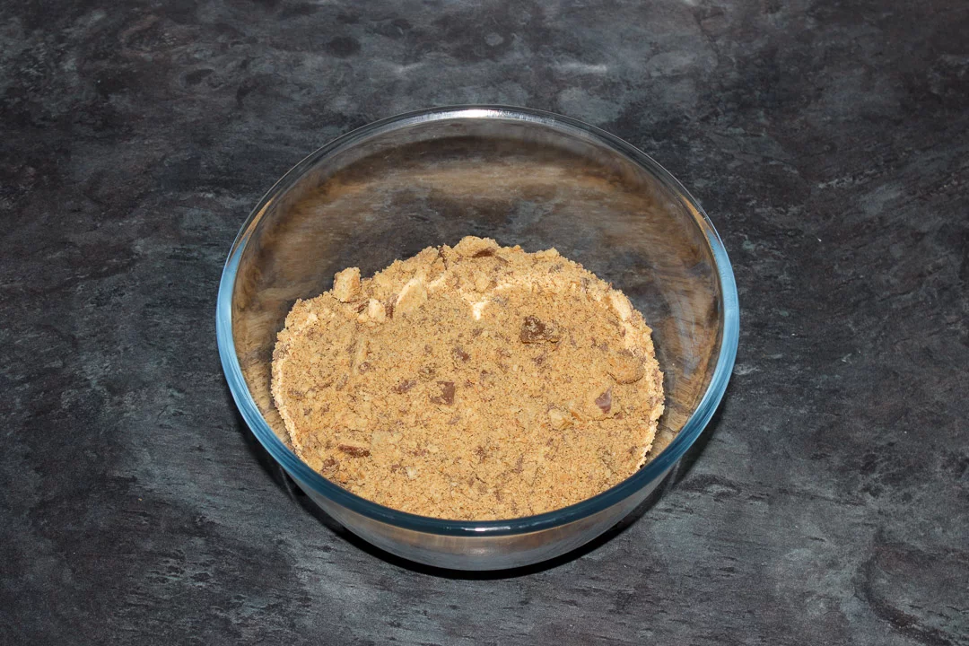 Dry ingredients for a tiffin recipe in a glass bowl