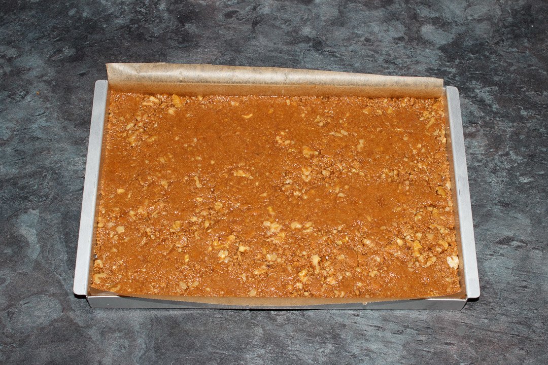 Tiffin recipe mixture that's been pressed into a rectangular baking tin