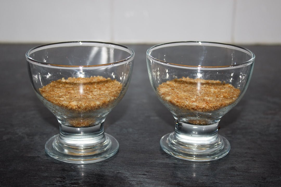 Glass bowls with a cheesecake base pressed into the bottom
