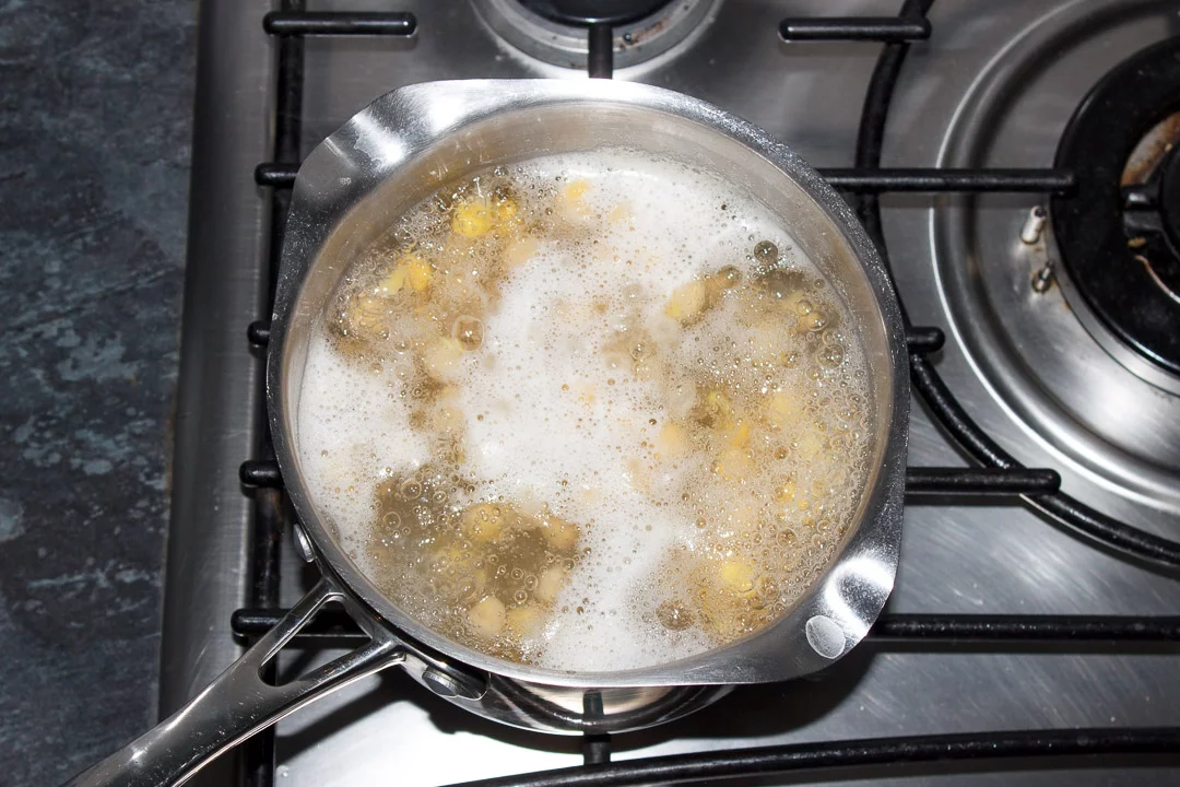 Chickpeas in boiling water in a saucepan
