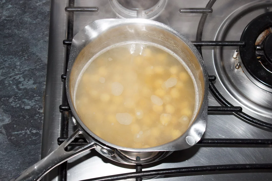 Boiled chickpeas in a pan of water