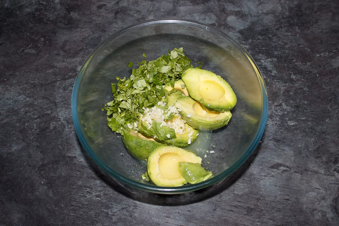 Guacamole ingredients in a glass bowl