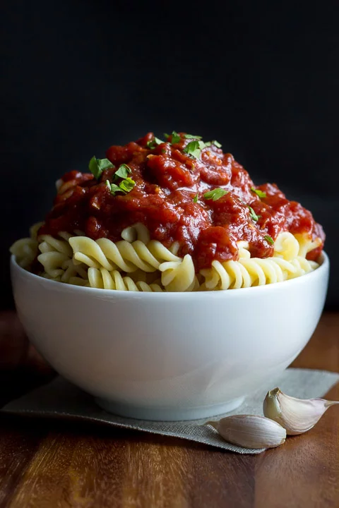Balsamic roasted tomato sauce on pasta in a white bowl