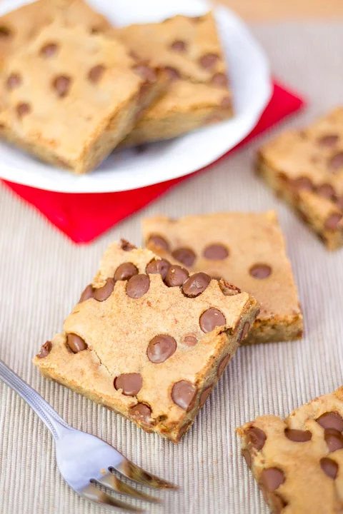 Chocolate chip cookie bars on a plate with a fork