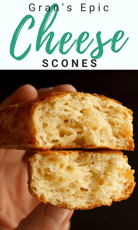 Two halves of a cheese scone being held so you can see the light flaky centre