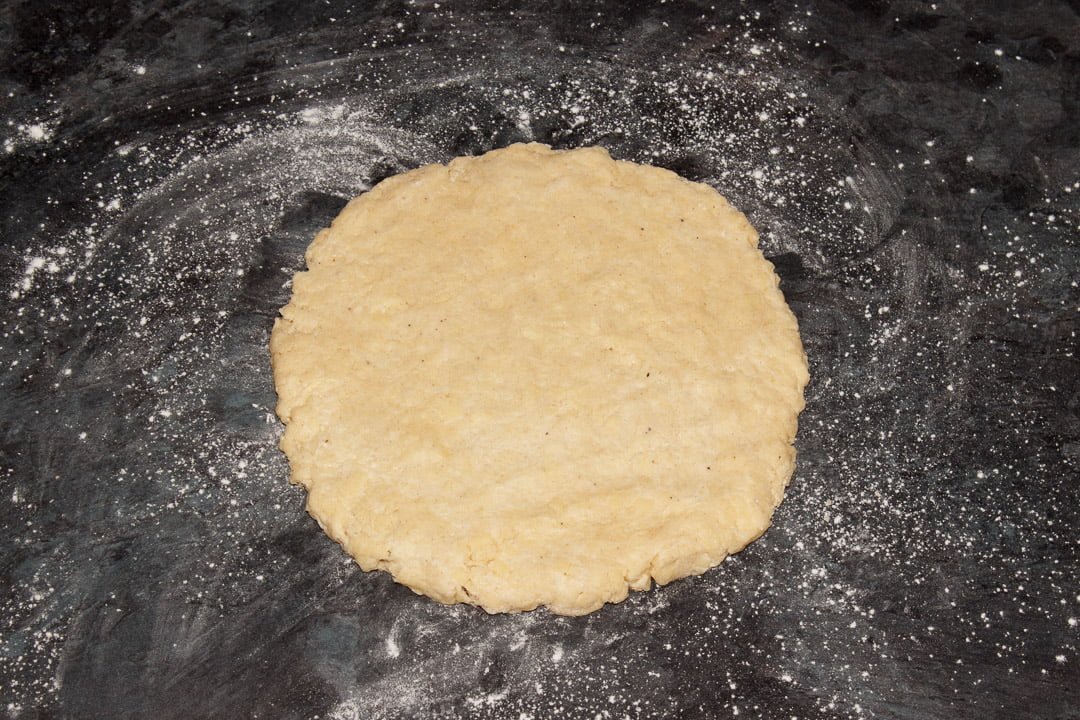 Cheese scones dough rolled out to a round on a lightly floured work surface