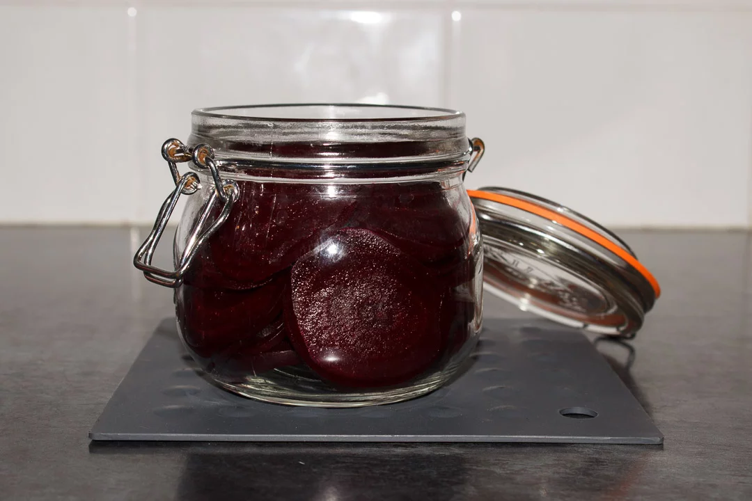 Sliced cooked beetroot in a sterilised jar