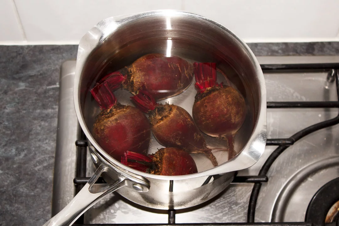 Washed whole beetroot with the stems trimmed in a large saucepan covered with water