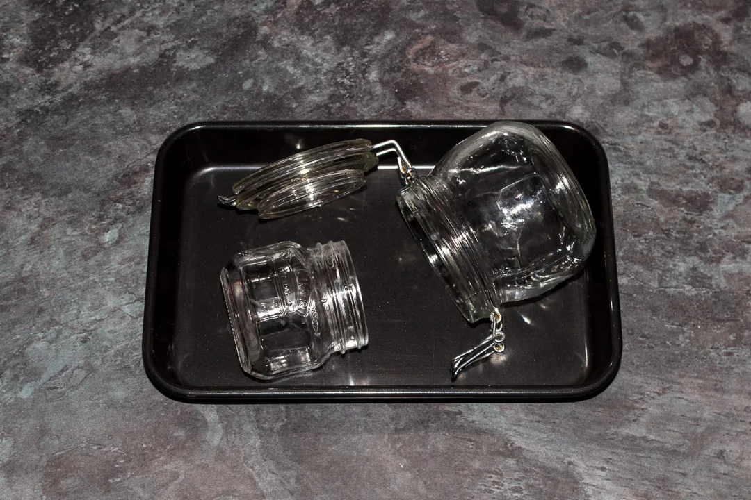 Clean jars on a baking tray ready to be sterilised in the oven