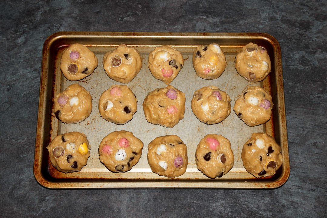 Mini Egg cookie dough balls on a baking tray