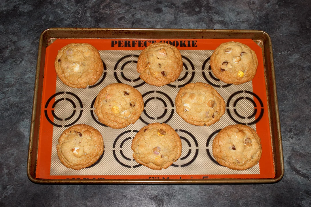 Baked Mini Egg cookies on a lined baking tray