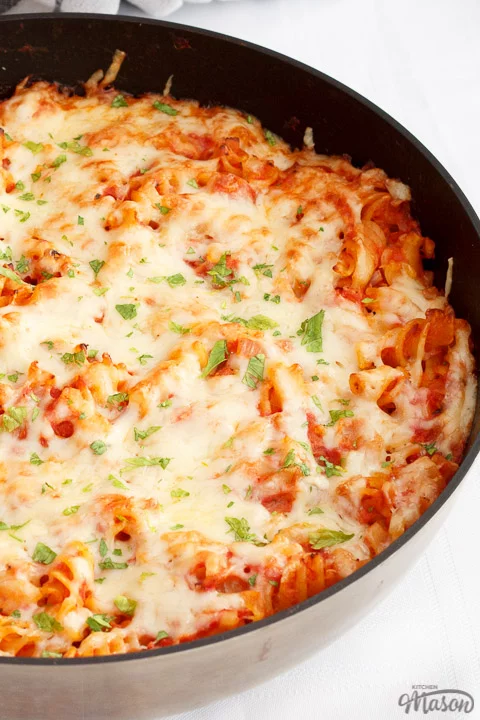Tuna pasta bake in a large frying pan on a white table cloth