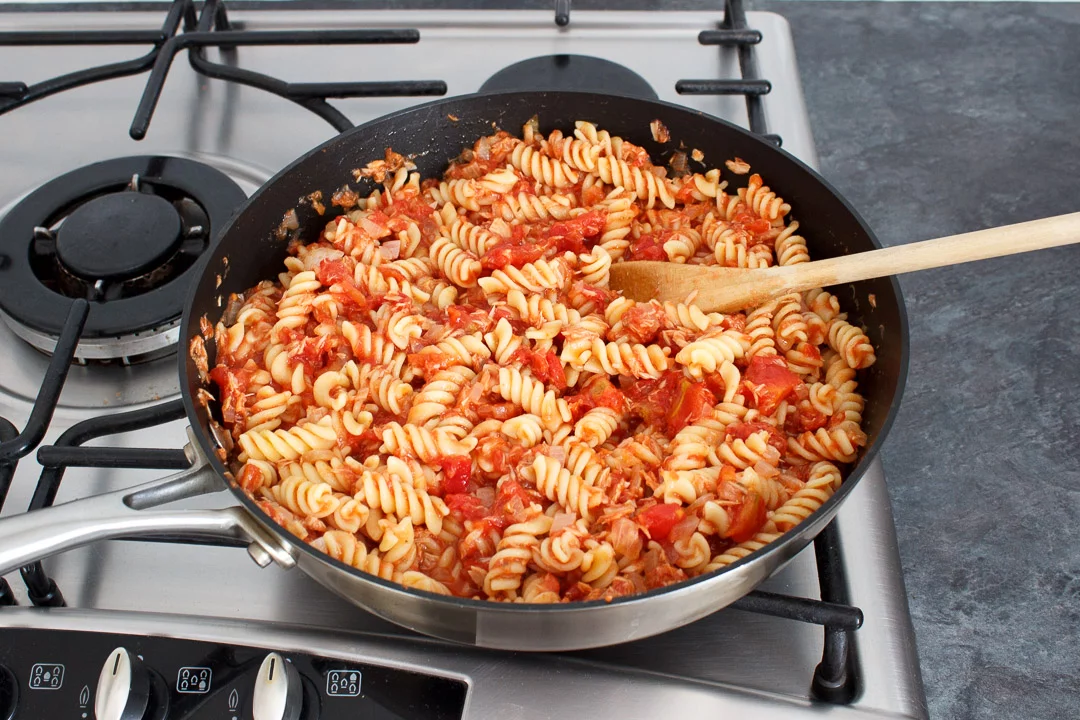 Tuna pasta bake in a large frying pan on a hob