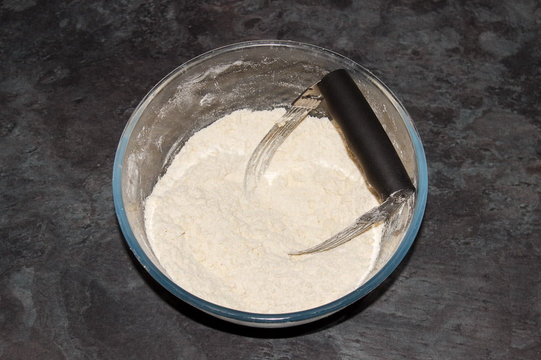 Flour, salt and butter in a fine breadcrumb consistency in a large glass bowl with a pastry blender