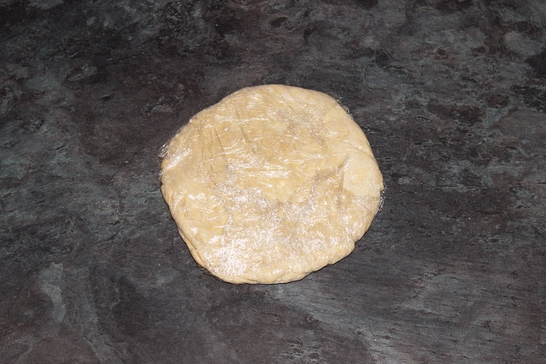 Shortcrust pastry wrapped in cling film and flattened into a disc.