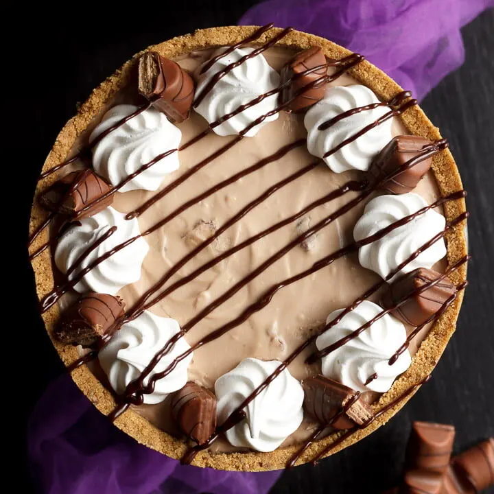 Birdseye view of Kinder Bueno cheesecake with purple tulle and Kinder Bueno bars in the background