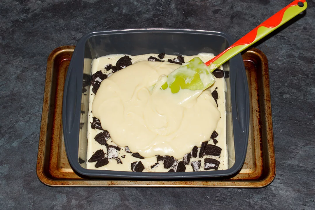 White chocolate fudge and chopped Oreos in a silicone baking pan
