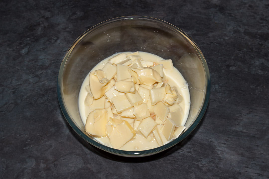 White chocolate, butter and condensed milk in a glass bowl
