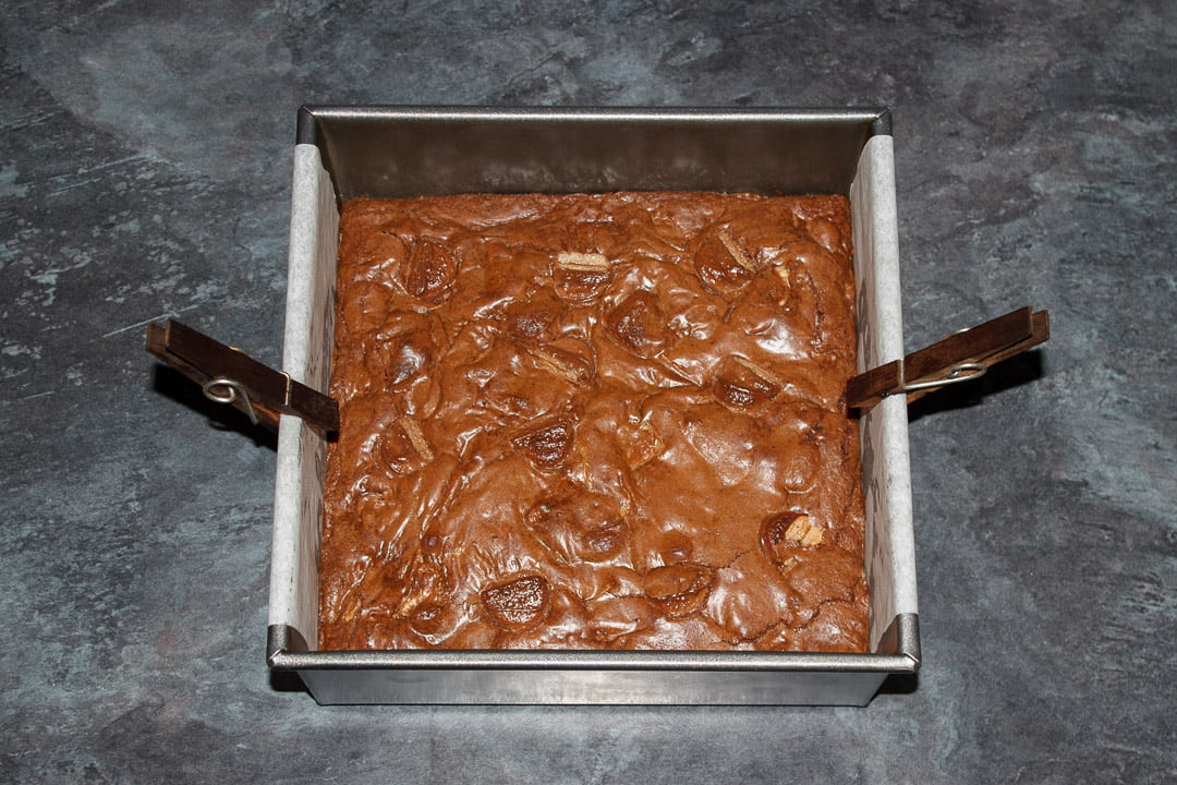 Baked Kinder Bueno Brownie in a lined baking tin