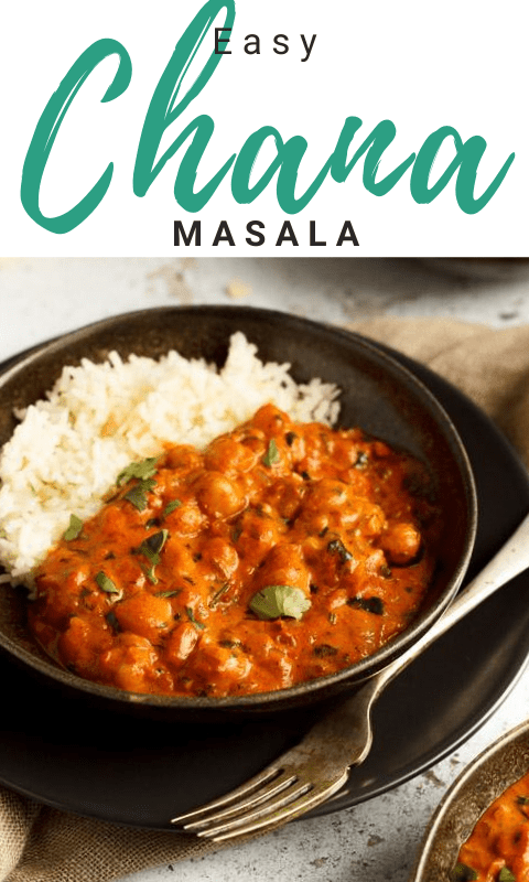 A bowl of chana masala curry and rice with a fork on a light brown napkin