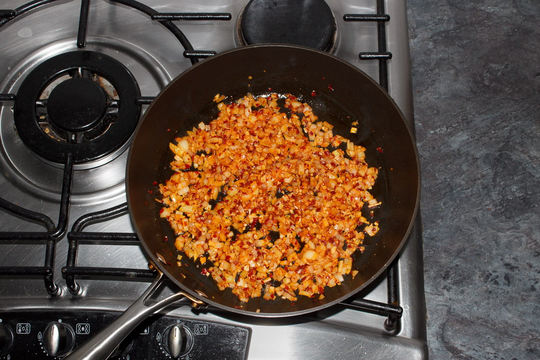 Onion, garlic, ginger and chilli frying in a large saucepan
