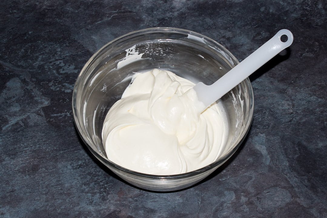No bake vanilla cheesecake filling in a glass bowl with a spatula