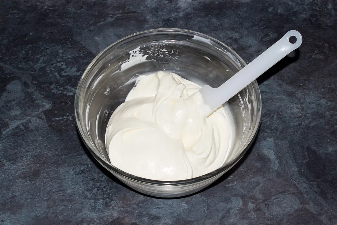 No bake vanilla cheesecake filling in a glass bowl with a spatula