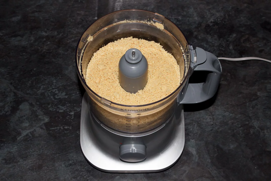 Crushed biscuit crumbs in a food processor
