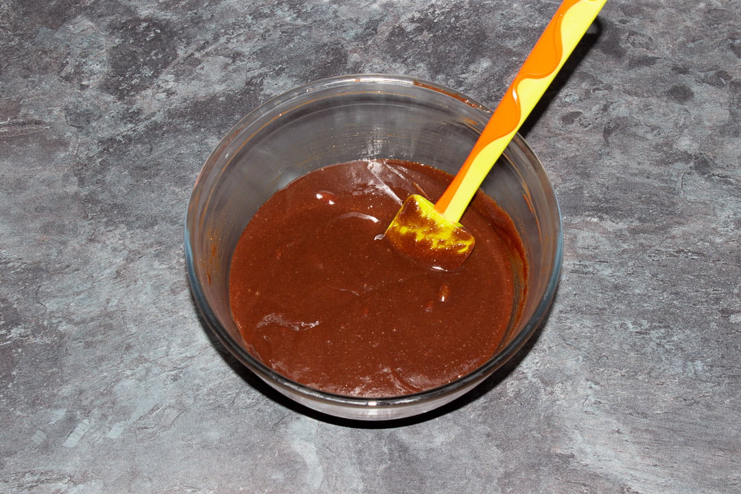 Melted dark chocolate, butter, eggs and sugar beaten together in a glass bowl with a rubber spatula
