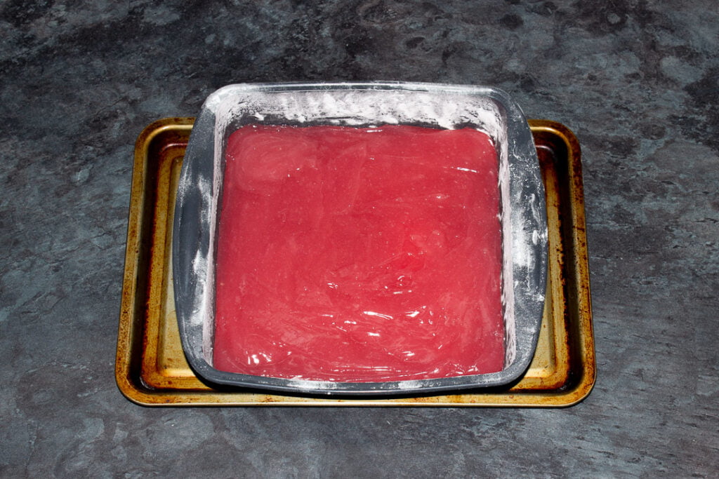 Turkish delight in a dusted silicone pan set on a baking tray on a kitchen worktop