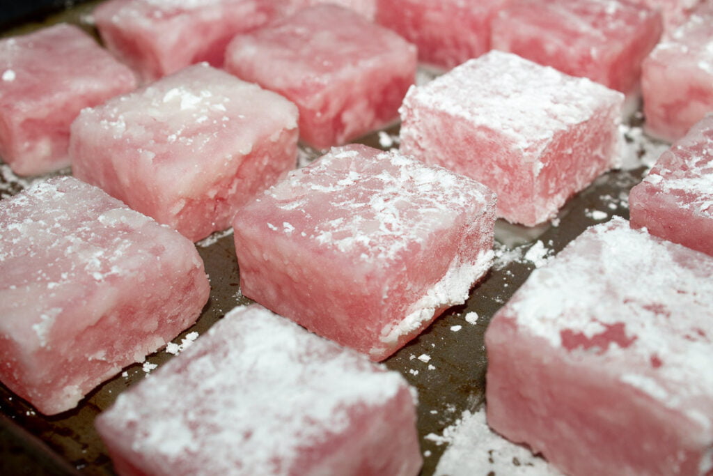 Turkish delight cubes on a baking tray with a cornflour crust on them