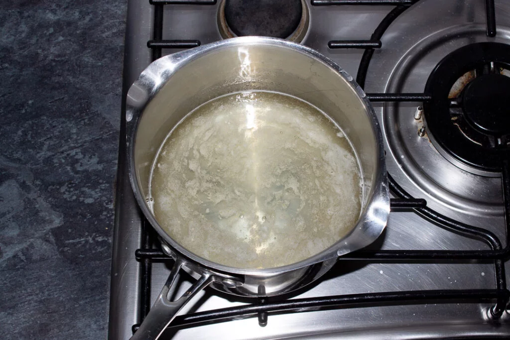 Sugar, lemon juice and water in a saucepan on the hob just beginning to simmer