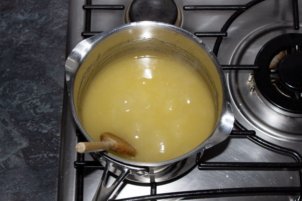 Sugar, lemon juice, water, cornflour and gelatine boiling in a saucepan on a hob