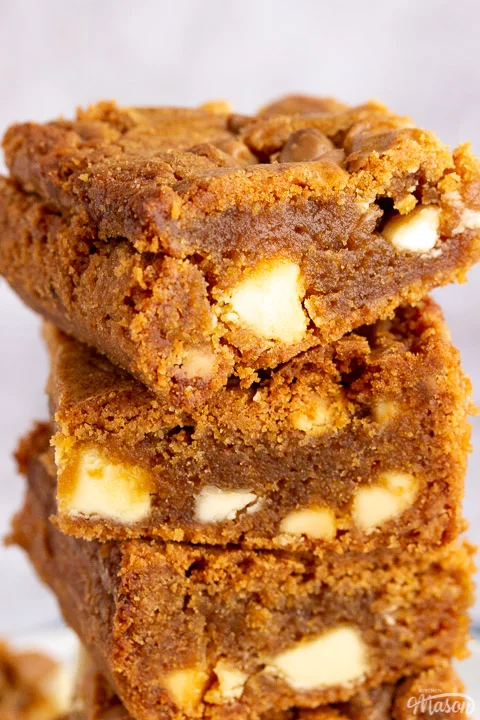 A close up of 3 Biscoff blondies stacked on top of each other
