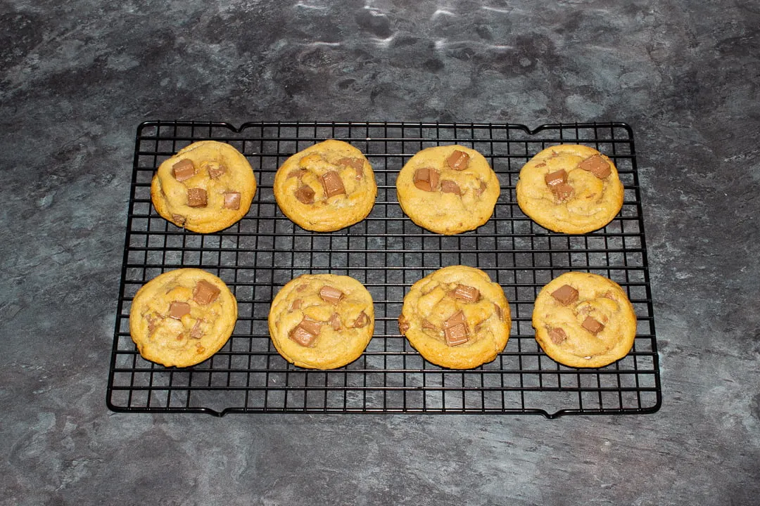 Baked chocolate chip cookies cooling on a wire rack