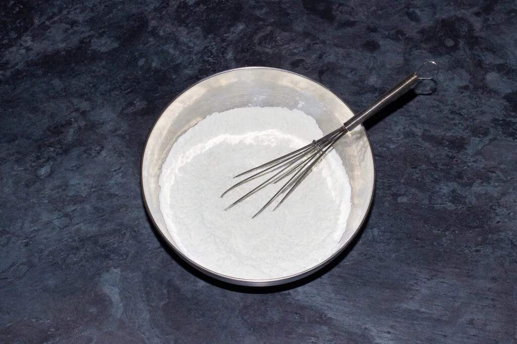 Flour, bicarbonate of soda and salt whisked together in a metal bowl
