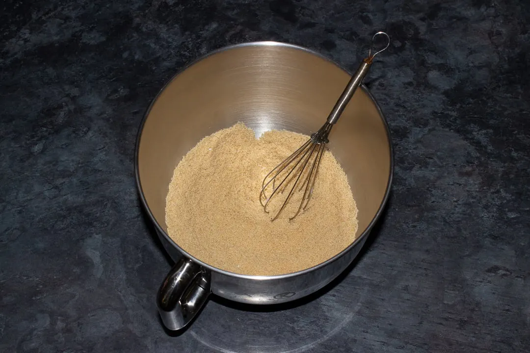 Soft light brown sugar and caster sugar whisked together in the bowl of an electric stand mixer with a hand whisk
