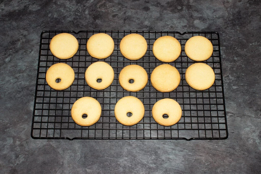Baked cookies on a black wire cooling rack