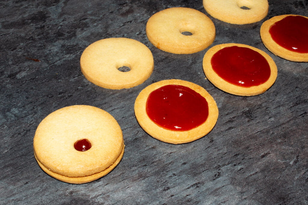 Reindeer cookies being sandwiched with jam