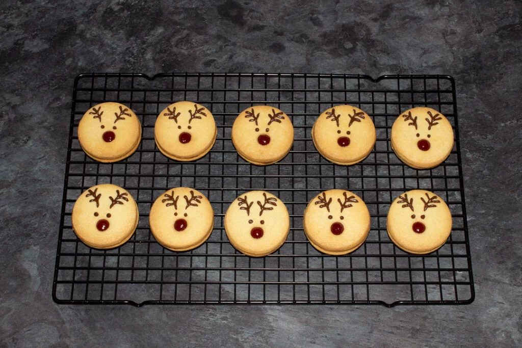 Reindeer cookies setting on a black wire cooling rack